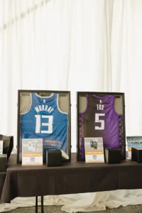 Framed NBA jerseys displayed for auction at Iron Mechanical’s Copper for Kids Annual Golf Tournament charity event.