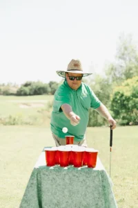 Golfer playing a fun cup toss game at Iron Mechanical’s Copper for Kids Annual Golf Tournament charity event.