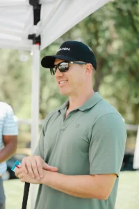 Golfer smiling during Iron Mechanical’s Copper for Kids Annual Golf Tournament community charity event.