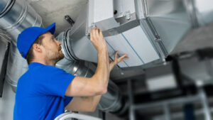 Sustainable HVAC Solutions - Iron Mechanical HVAC technician inspecting commercial ductwork in California.
