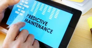 Close-up of a person using a tablet displaying the words “Predictive Maintenance,” representing digital solutions for proactive construction system management.