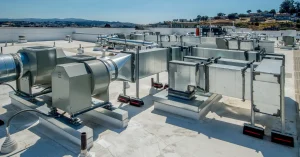 Rooftop HVAC system installation featuring large air ducts, ventilation fans, and mechanical units, designed for commercial or healthcare facility climate control and air quality management.